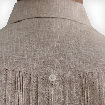 Beige guayabera shirt paired with white trousers