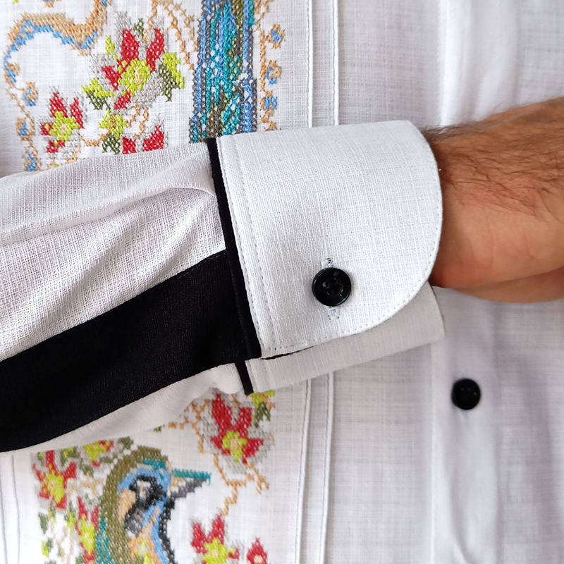 Close-up of Mayan Toh bird embroidery on white guayabera