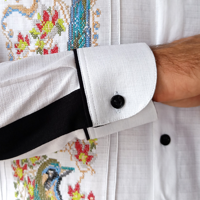 Close-up of Mayan Toh bird embroidery on white guayabera