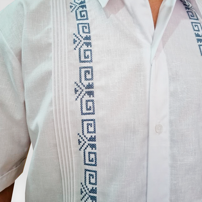 Close-up of blue embroidery on white modern-fit guayabera