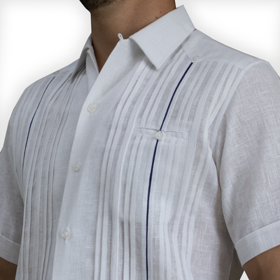 Close-up of blue trim detail on luxury white short-sleeve guayabera