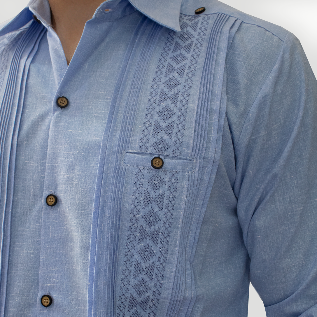 Close-up of handmade blue embroidery on men’s long sleeve guayabera