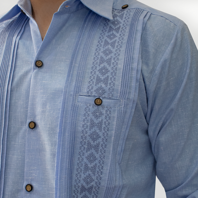 Close-up of handmade blue embroidery on men’s long sleeve guayabera