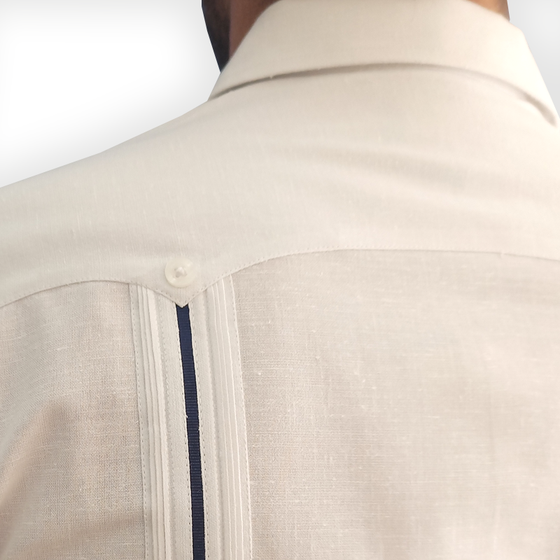 Close-up of navy blue trim on white long-sleeve wedding guayabera