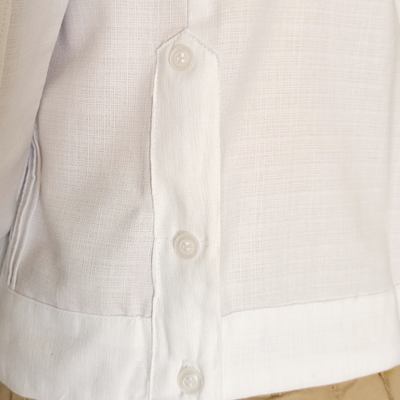 Close-up of tropical floral embroidery on white guayabera