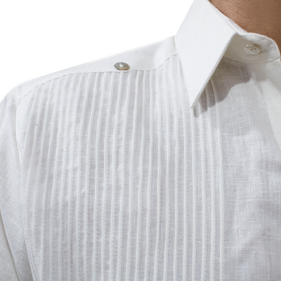 Close-up of white embroidery on men’s white linen guayabera