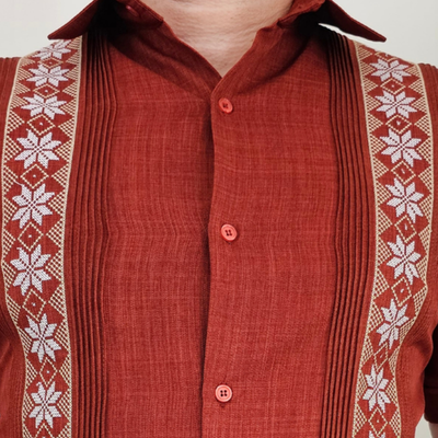 Detail of vertical pleats and stitching on burnt orange long sleeve guayabera
