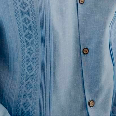Handmade embroidery detail on light blue guayabera