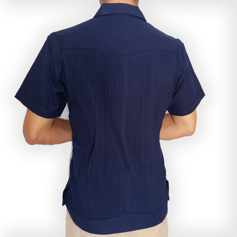 Man wearing navy blue short sleeve guayabera with white trousers