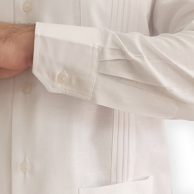 Man wearing white Cuban guayabera with dress trousers