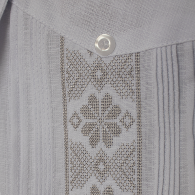 Man wearing white guayabera with grey embroidery