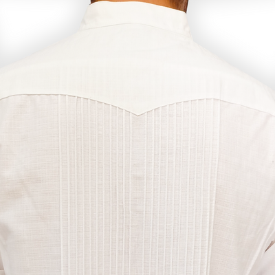 Man wearing white long-sleeve guayabera with linen trousers