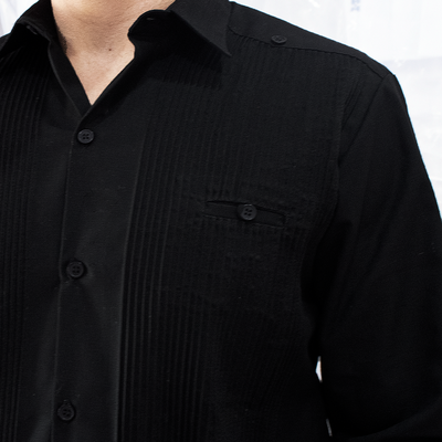 Pleated front detail on black guayabera shirt
