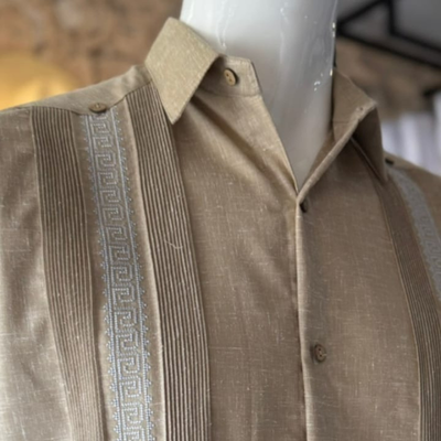 close-up of beige embroidered guayabera fabric