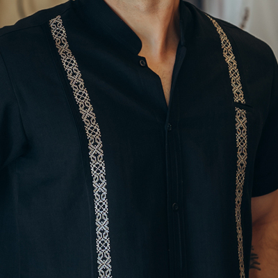 close-up of black guayabera embroidery detail