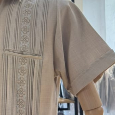close-up of embroidery on beige guayabera