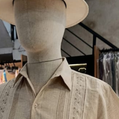 close-up of embroidery on beige guayabera shirt