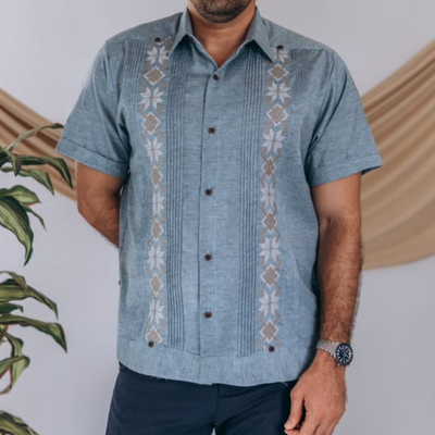 close-up of embroidery on blue guayabera
