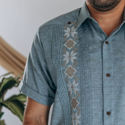 close-up of embroidery on blue guayabera shirt