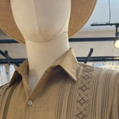 close-up of embroidery on camel guayabera