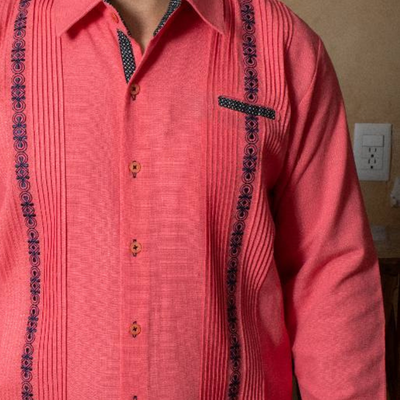 close-up of embroidery on coral pink guayabera shirt