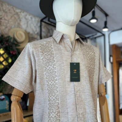 close-up of embroidery on cream guayabera