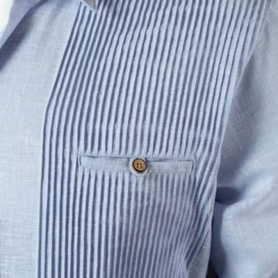 close-up of light blue presidential guayabera fabric