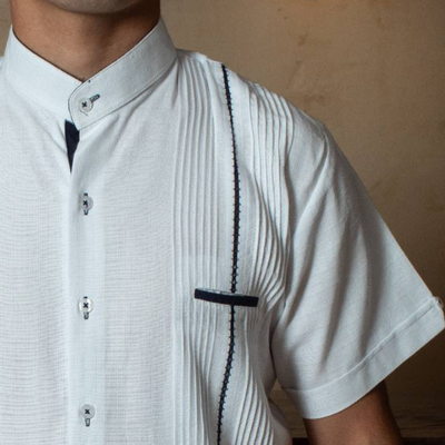 close-up of navy embroidered panels on white guayabera
