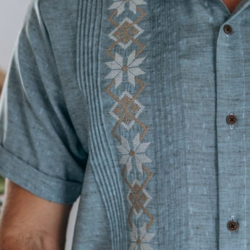 detail of decorative embroidery on blue fabric
