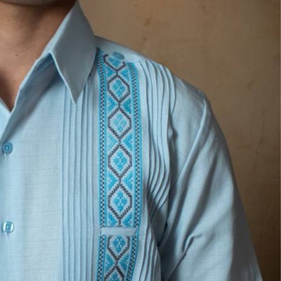 hand embroidery detail on sky blue guayabera shirt