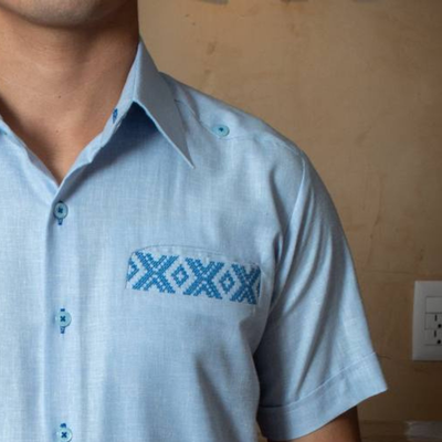 hand embroidery detail on sky blue short sleeve guayabera shirt
