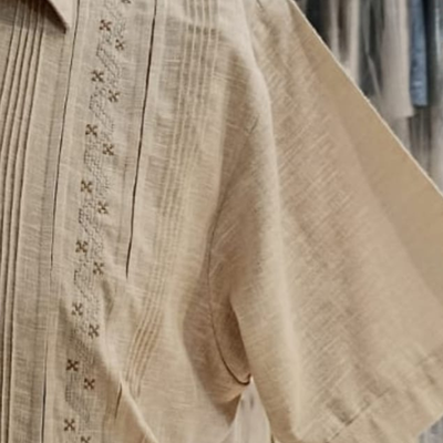 man wearing beige embroidered guayabera shirt
