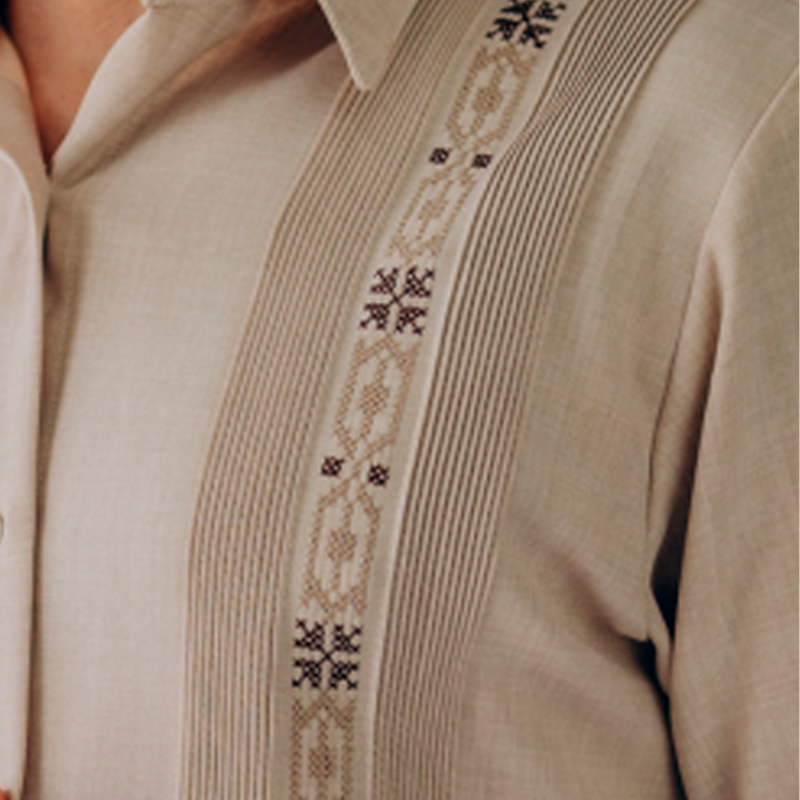 man wearing beige embroidered short sleeve guayabera shirt