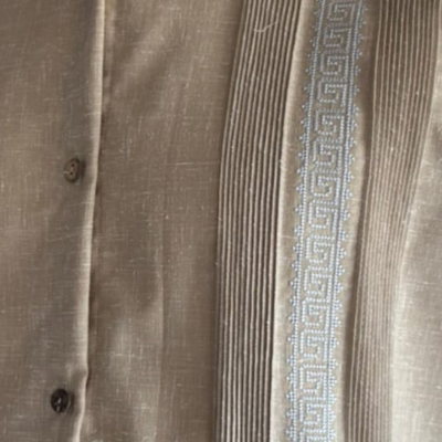 man wearing beige short sleeve embroidered guayabera