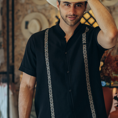 man wearing black embroidered short sleeve guayabera