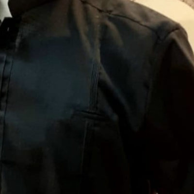 man wearing black mandarin collar guayabera