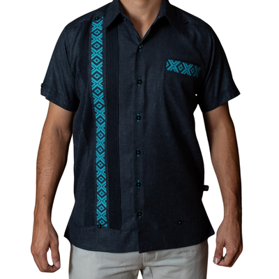man wearing dark blue guayabera with turquoise embroidery