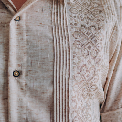 man wearing embroidered beige short sleeve guayabera