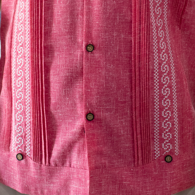 man wearing pink short sleeve embroidered guayabera