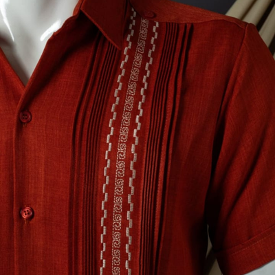 man wearing red short sleeve embroidered guayabera