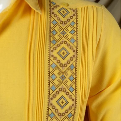 man wearing yellow embroidered long sleeve guayabera